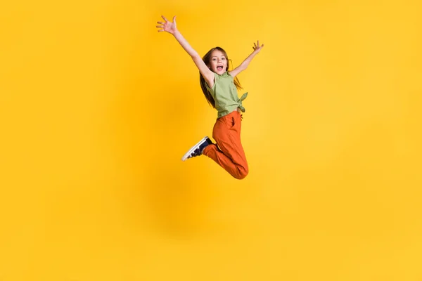 Full length body size photo little girl jumping up cheerful isolated vibrant yellow color background — Stock Photo, Image