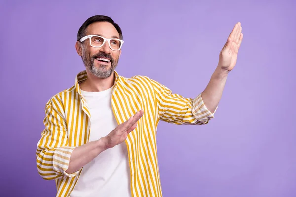 Photo positive gaie homme heureux mature regarder vide espace lever les mains danse isolé sur fond de couleur violette — Photo