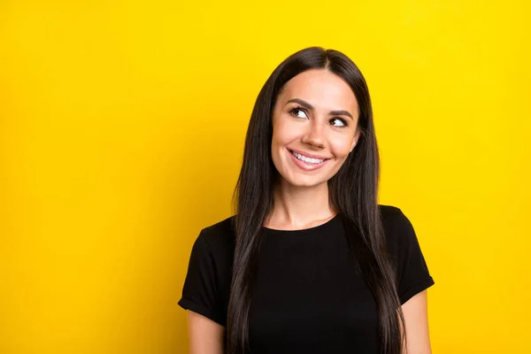 Photo of dreamy curious ladylook up empty space wear black t-shirt isolated yellow color background — Stock Photo, Image