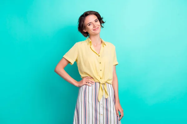 Φωτογραφία του νεαρού ελκυστική κοπέλα ευτυχής θετικό χαμόγελο χέρι στη μέση φορούν μπλούζα απομονωμένη πάνω από τυρκουάζ φόντο χρώμα — Φωτογραφία Αρχείου