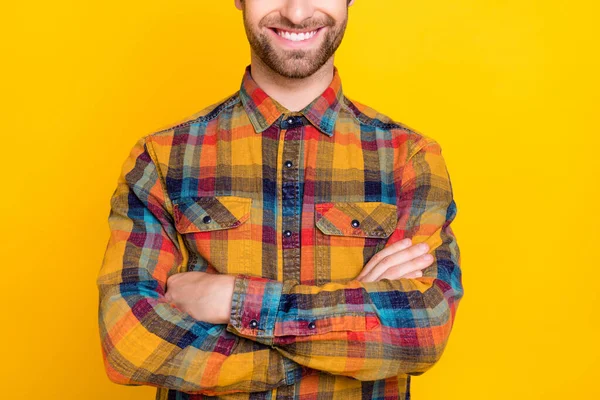 Photo of confident charming young man wear plaid shirt smiling hands folded isolated yellow color background — Stock Photo, Image