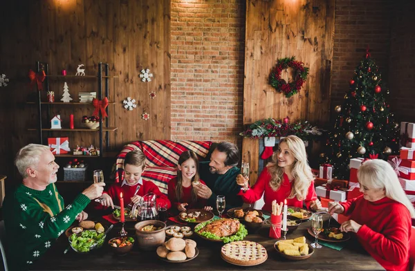 Photo of family friends small little childhood children people eat parents noel sit big table clink glass toast x-mas indoors house — Stock Photo, Image