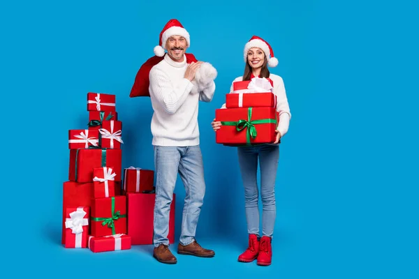 Full length body size view of attractive cheerful couple delivering giftboxes festal day isolated over bright blue color background — Stock Photo, Image