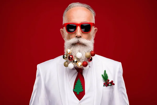 Ciddi, havalı bir adamın fotoğrafı güneş gözlüğü takıyor sakal dekoru takıyor kırmızı arka planda izole edilmiş ağaç kravatı takıyor. — Stok fotoğraf