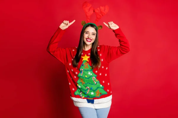 Foto di felice affascinante giovane donna punta dito indossare cervo cervo sorriso isolato su sfondo di colore rosso — Foto Stock