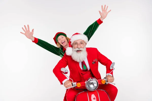 Portrait of attractive carefree cheerful friends riding motor bike having fun christmastime isolated over white color background — Stock Photo, Image