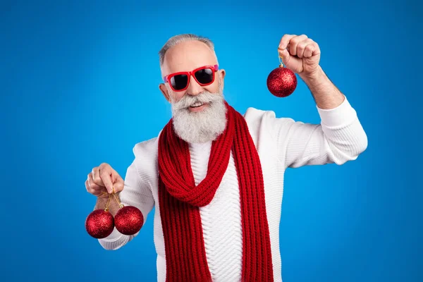 Bild av charmig vacker ålder gentleman bära tröja glasögon leende hålla jul dekorationer isolerad blå färg bakgrund — Stockfoto