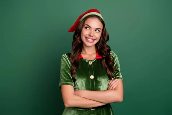 Portrait of attractive cheerful curious girl elf folded arms deciding festal event isolated over green color background — Stock Photo, Image