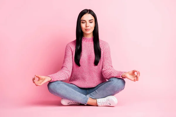 Full size photo of pretty person sit on floor closed eyes fingers meditate isolated on pink color background — Stock Photo, Image
