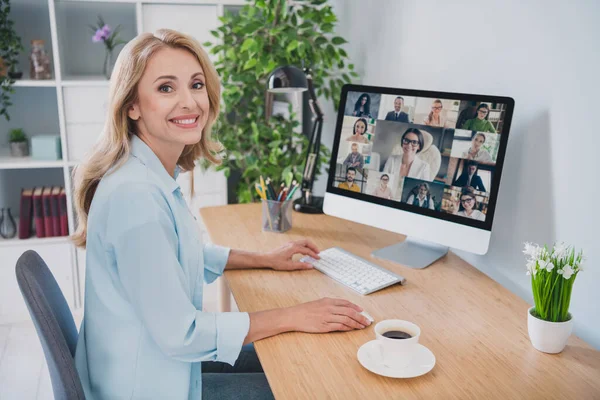Photo of sweet adorable age woman dressed blue shirt sitting table having online meeting modern gadget smiling indoors home room — Stock Photo, Image