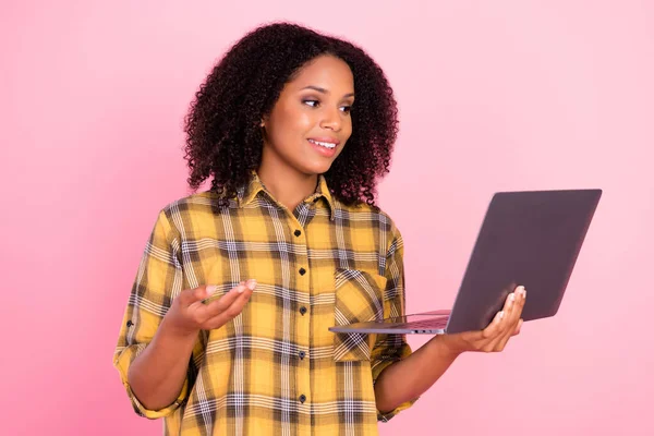 Photo de dame sociable tenir ordinateur portable conversation vidéo porter chemise à carreaux isolé fond de couleur rose — Photo