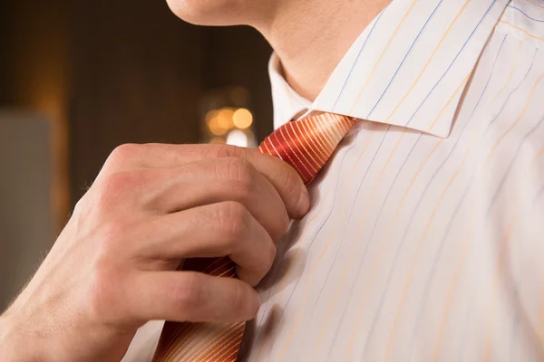 Good looking business. Cropped image of young man in adjusting his necktie — Stock Photo, Image