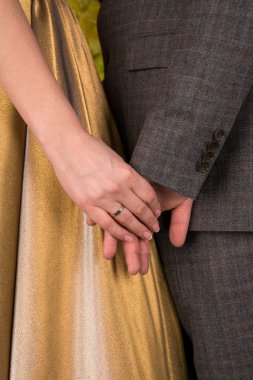 Man holding the hand of his woman clipart