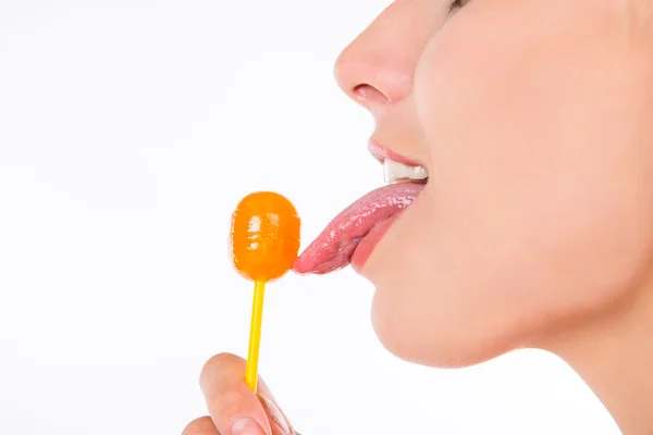 Closeup photo of girl licking a lollipop — Stock Photo, Image