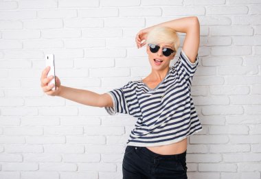 girl with glasses making selfie clipart