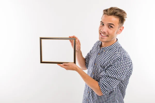 Handsome man holding a picture frame — Stock Photo, Image
