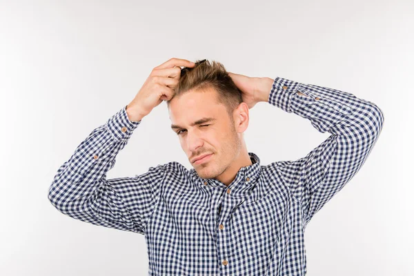 Handsome young man brushing his hair — Stock Photo, Image