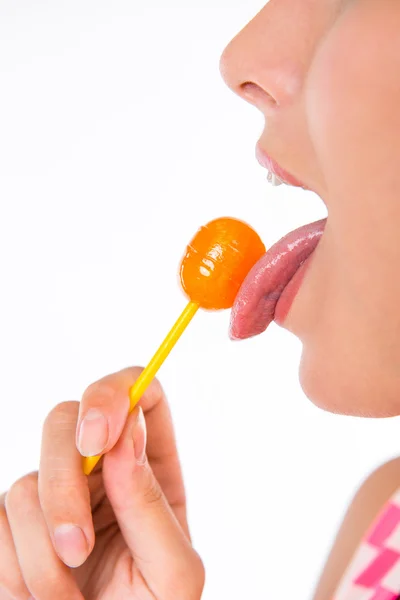 Closeup photo of girl licking a lollipop — Stock Photo, Image