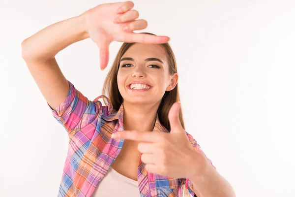 young woman gesturing finger frame and smiling
