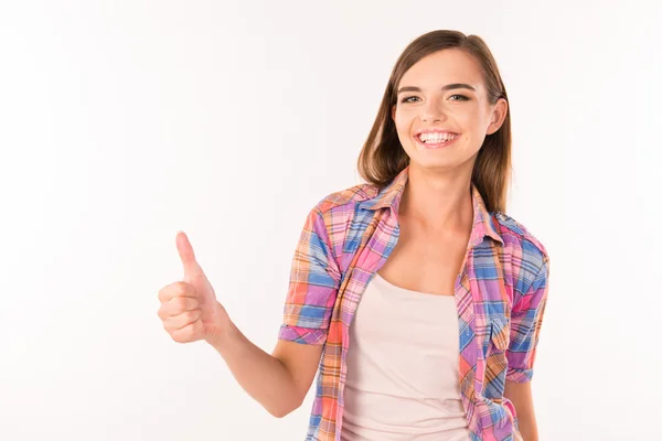 Girl showing thumbs up and smiling — Stock Photo, Image