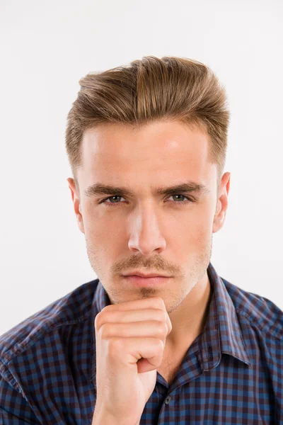 Serious man thinking with his hand on chin — Stock Photo, Image