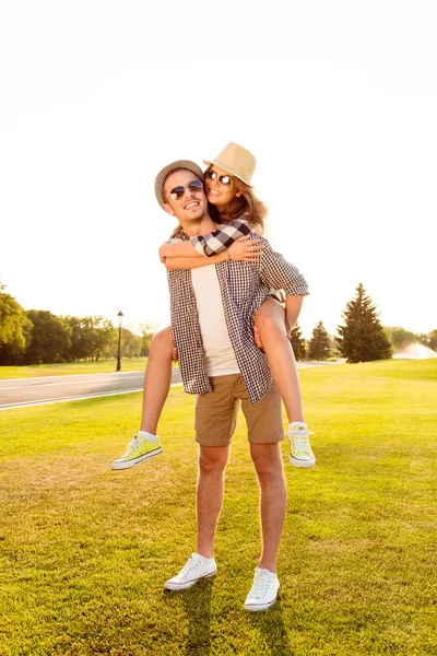 Happy Young Man Piggyback His Girlfriend . — стоковое фото