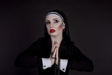 Halloween. Girl dressed in evil sexy nun clipart