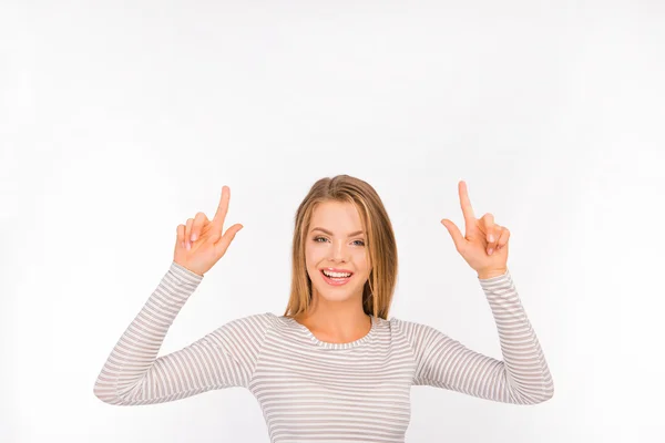 Smiling pretty young girl pointing away — Stock Photo, Image