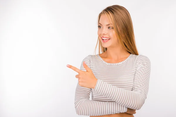 Happy pretty young girl pointing away — Stok fotoğraf