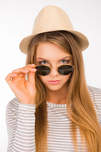 Sexy girl with a hat put the glasses on her nose — Stockfoto