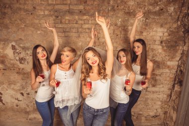 Good-looking bride and happy bridesmaids celebrating hen-party w clipart