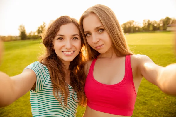 Two nice-looking cheerful girls making selfie photo — Stock Photo, Image