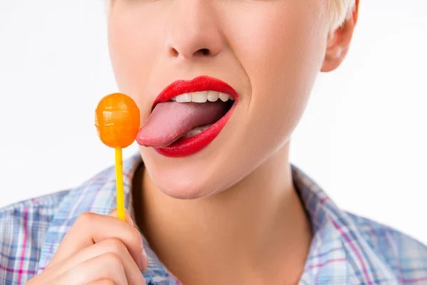 Closeup photo of a girl licking a lollipop — Stock Photo, Image