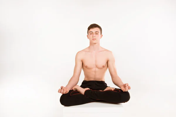 Young man meditating isolated on white background. man doing yog — Stock Photo, Image