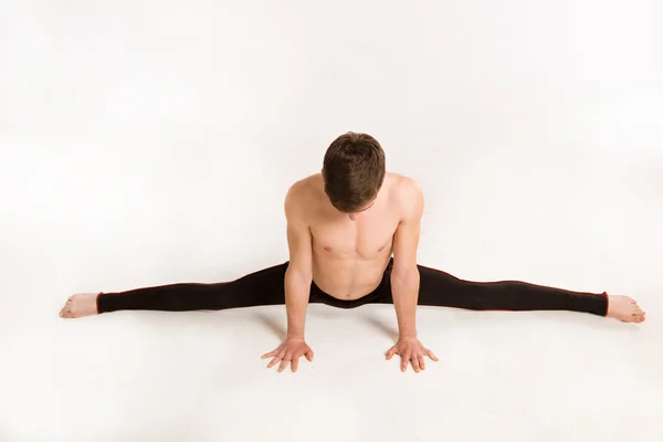 Slender man doing gymnastic exercises — Stock Photo, Image