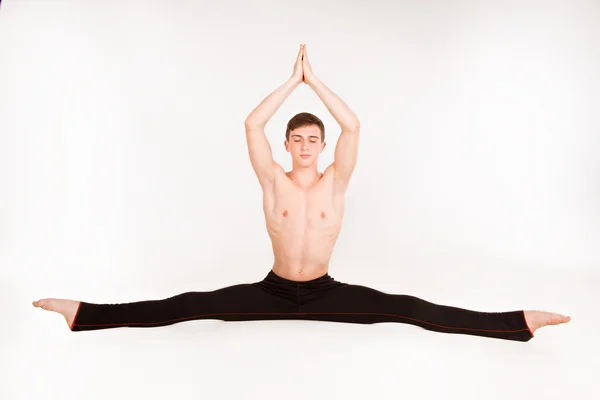 Slender man doing gymnastic exercises — Stock Photo, Image