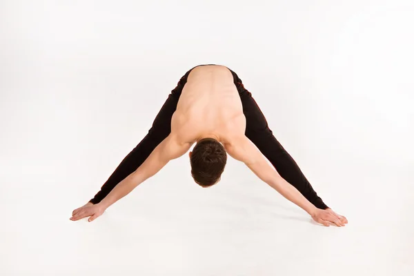 Slender man doing gymnastic exercises. — Stock Photo, Image