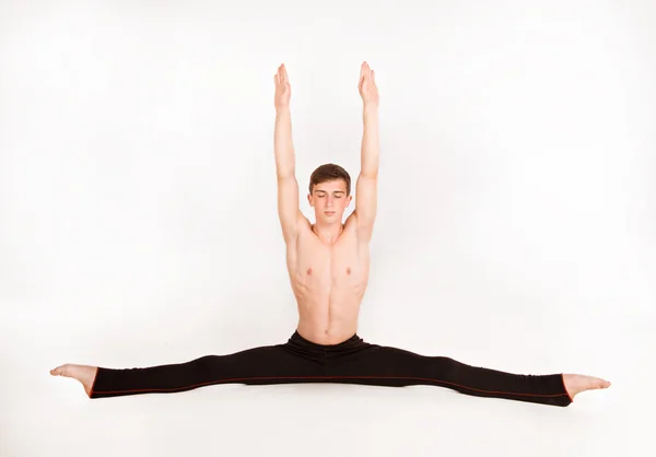 Slender man doing gymnastic exercises — Stock Photo, Image