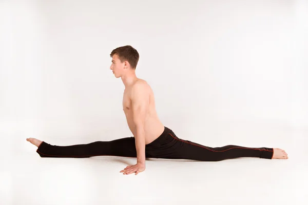 Slender man doing gymnastic exercises — Stock Photo, Image