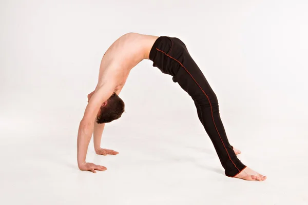 Slender man doing gymnastic exercises. Gymnast doing gymnastic b — Stock Photo, Image