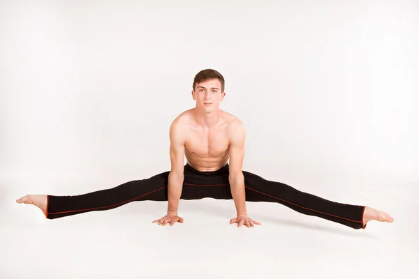 Slender man doing gymnastic exercises — Stock Photo, Image