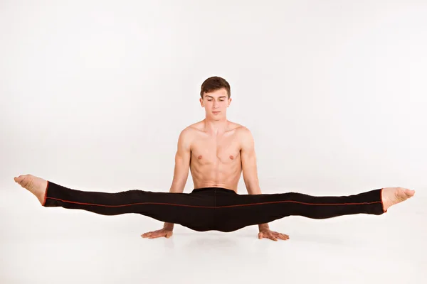 Slender man doing gymnastic exercises — Stock Photo, Image