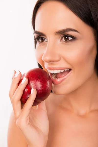 Beautiful healthy girl biting a nectarine — Stock Photo, Image