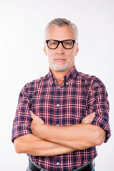 Confident gray aged man with glasses crossing his arms — Stock Photo, Image