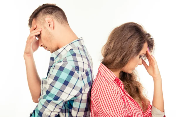 Young couple standing back to back — Stock Photo, Image