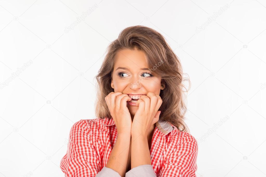 Portrait of scared woman waiting for special moment biting nails Stock