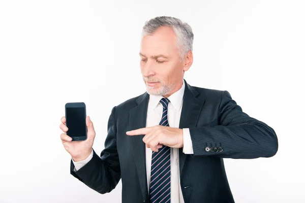Old handsome man in business suit pointing to the phone — Stock Photo, Image