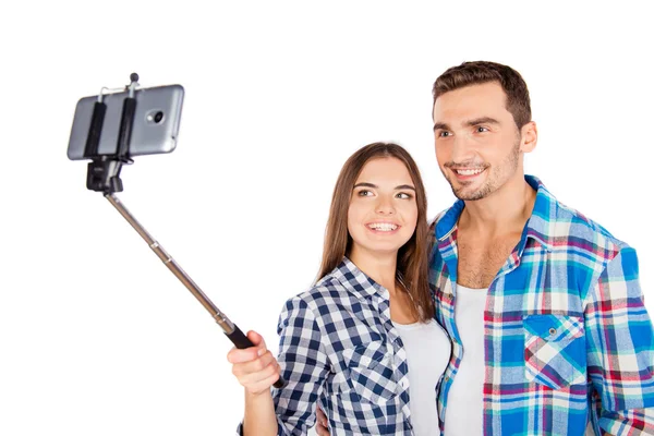 Cheerful couple in love making selfie photo with selfie stick — Stock Photo, Image