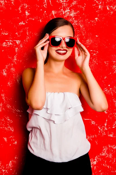 Glamorous cheerful girl with red lips with spectacles against th Stock Image