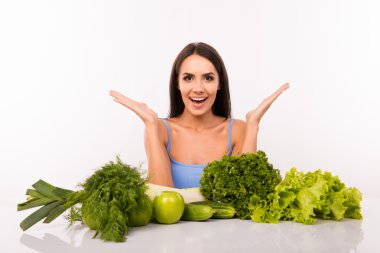 Surprised beautiful girl on a diet with vegetables clipart